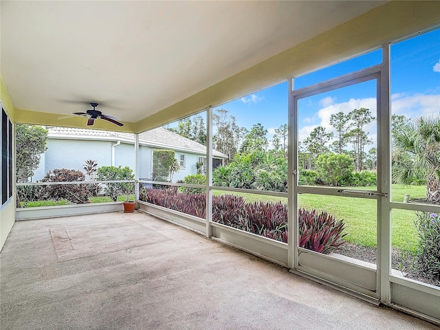 unfurnished sunroom with ceiling fan and a wealth of natural light