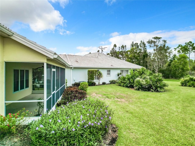 view of yard featuring a sunroom