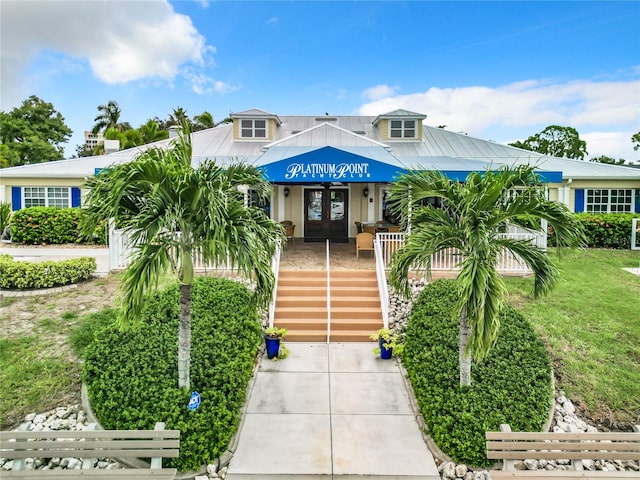 view of front of home with a porch and a front lawn