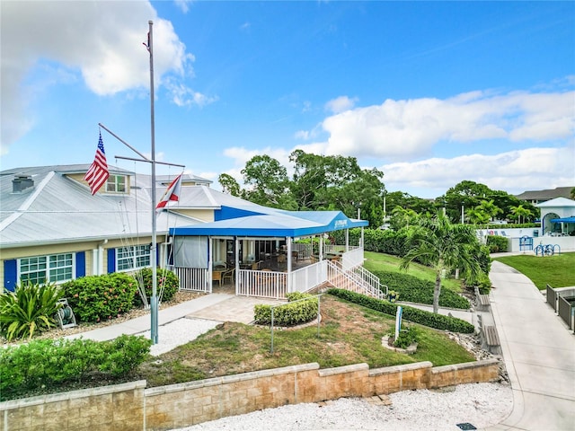 back of property with a porch and a lawn