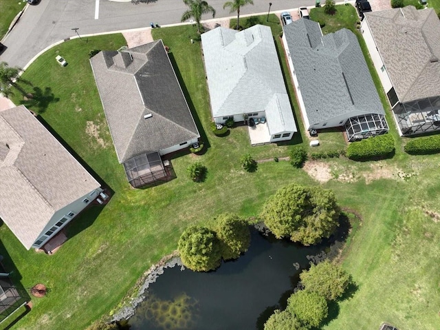 drone / aerial view with a water view and a residential view