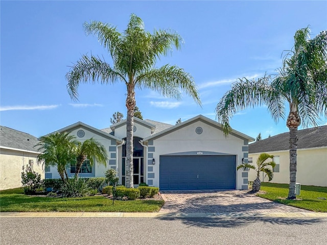 ranch-style house with a garage and a front lawn