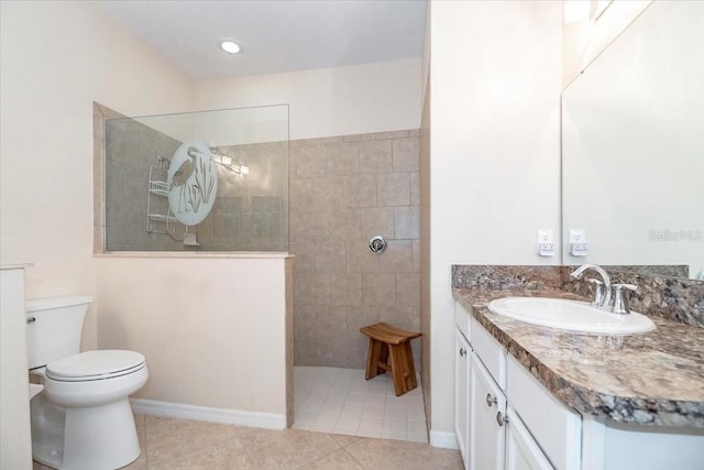 full bath featuring tile patterned floors, vanity, toilet, and a walk in shower