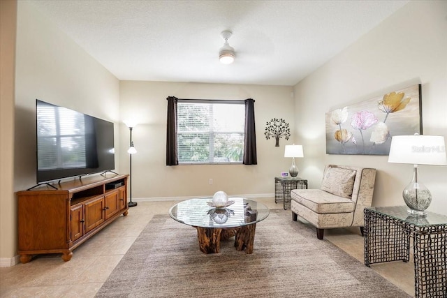 living room with light tile patterned floors and baseboards