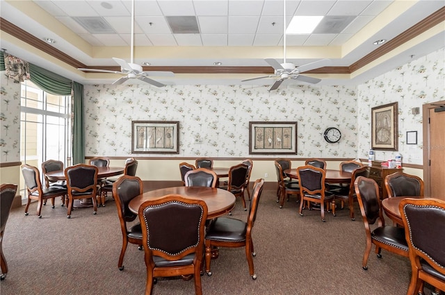 dining room with a raised ceiling, carpet flooring, wainscoting, and wallpapered walls