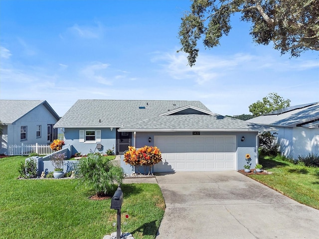 single story home featuring a garage and a front yard