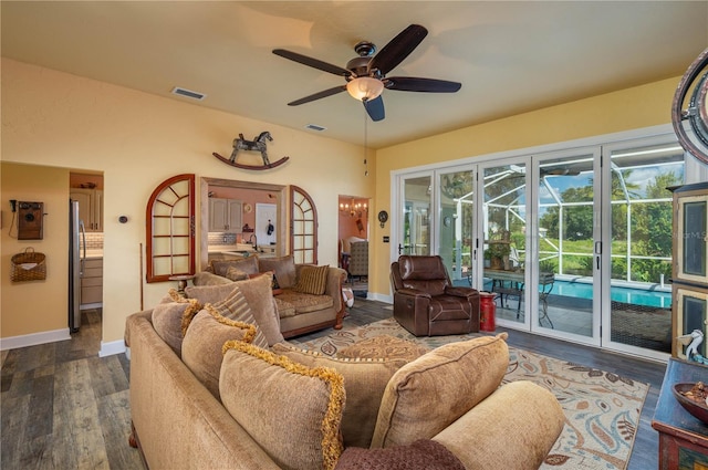 living room featuring ceiling fan and dark hardwood / wood-style flooring