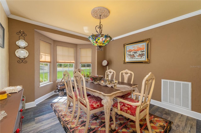 dining room featuring crown molding and dark hardwood / wood-style flooring