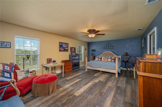 bedroom with ceiling fan and dark hardwood / wood-style floors