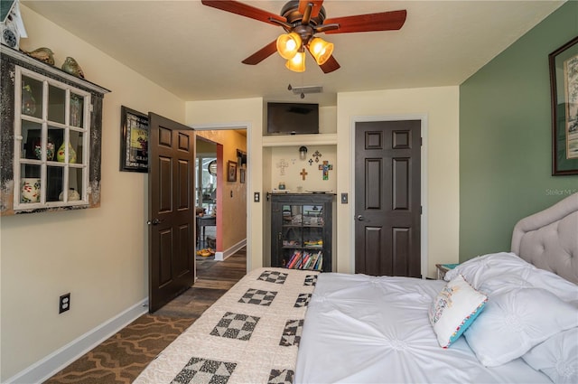 bedroom with ceiling fan and dark hardwood / wood-style flooring