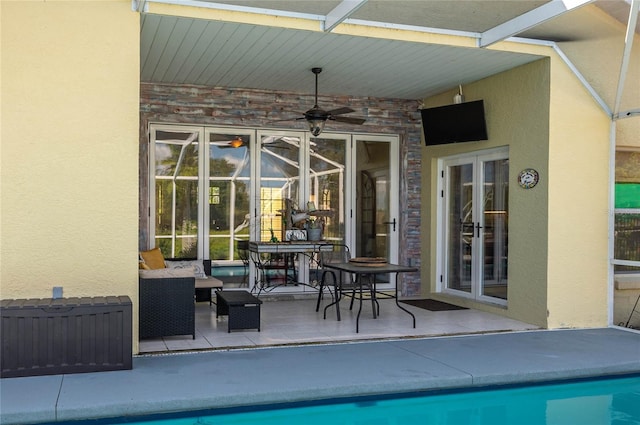 view of pool with french doors, an outdoor hangout area, a patio, and ceiling fan