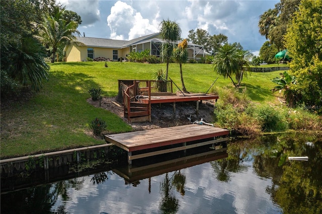 dock area with a yard and a deck with water view