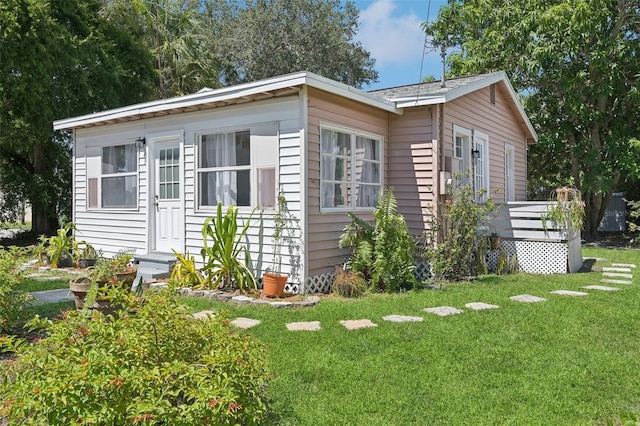 view of home's exterior with a wooden deck and a yard