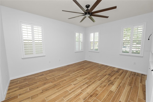 unfurnished room featuring ceiling fan, plenty of natural light, and light hardwood / wood-style flooring