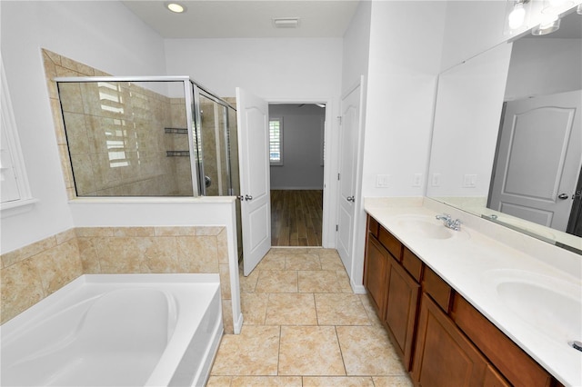 bathroom featuring tile patterned floors, plus walk in shower, and vanity