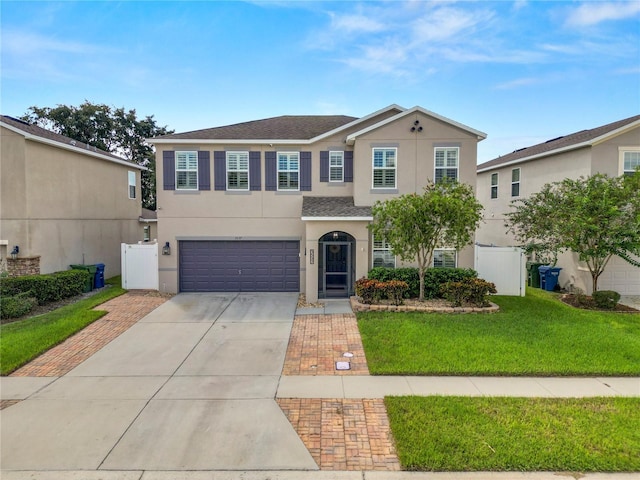 view of front of property featuring a garage and a front yard