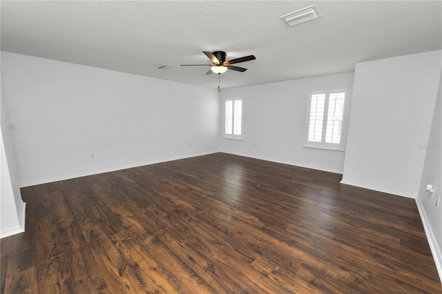 unfurnished room with a textured ceiling, dark wood-type flooring, and ceiling fan