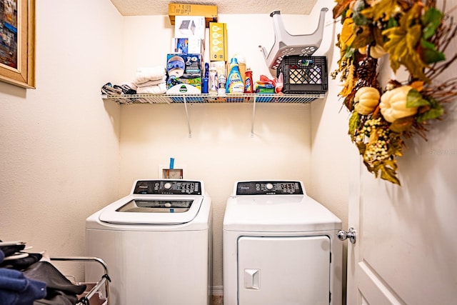 laundry room featuring washer and dryer and a textured ceiling