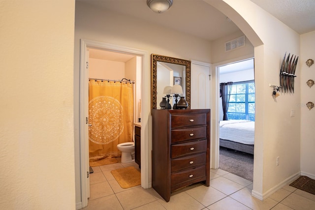 hallway featuring light tile patterned flooring