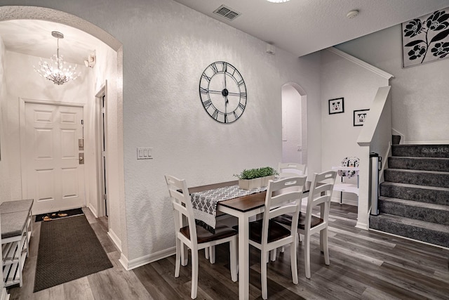 dining space with a notable chandelier and dark hardwood / wood-style flooring