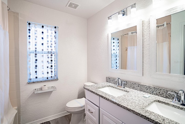 bathroom featuring walk in shower, wood-type flooring, vanity, and toilet