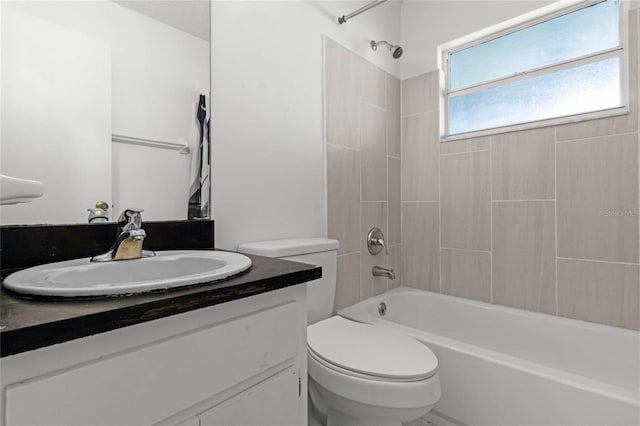 full bathroom with vanity, toilet, and tiled shower / bath combo