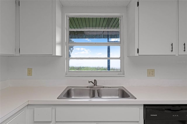 kitchen featuring sink, white cabinets, and black dishwasher