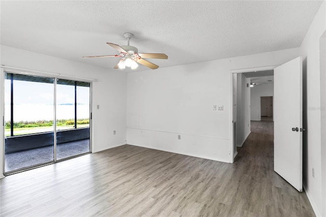 unfurnished room featuring ceiling fan, a textured ceiling, and light hardwood / wood-style flooring