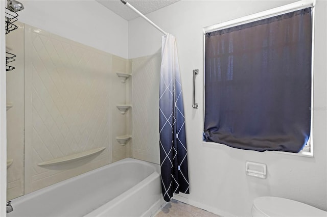 bathroom featuring tile patterned floors, toilet, shower / tub combo, and a textured ceiling