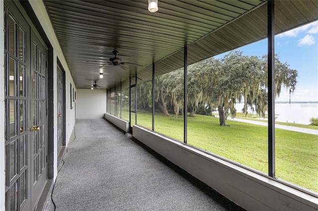 unfurnished sunroom with a water view and a wealth of natural light