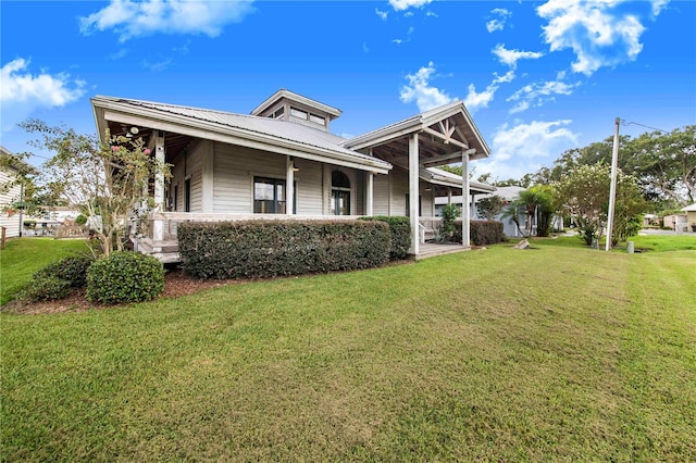 view of property exterior with covered porch and a yard