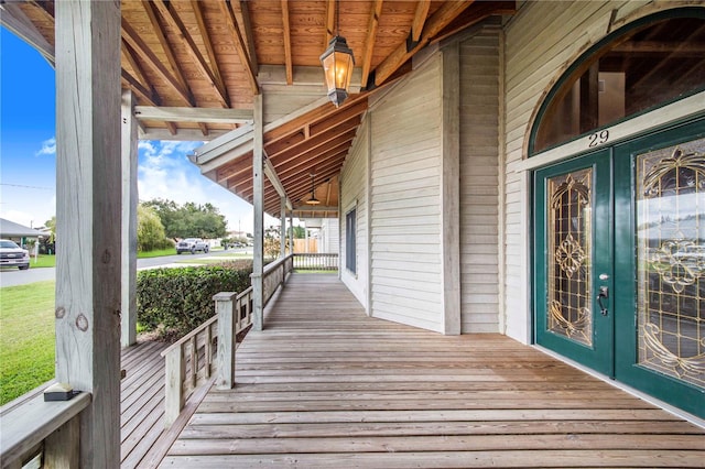 wooden deck with french doors and a porch