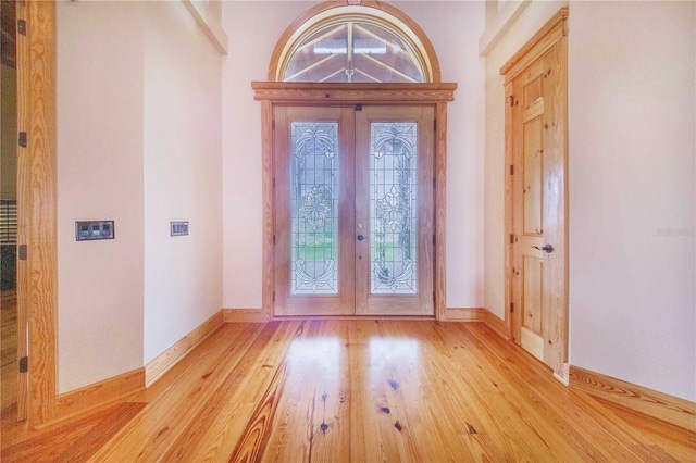 entrance foyer with light hardwood / wood-style flooring and french doors