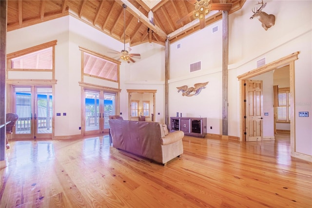 living room featuring ceiling fan, wood ceiling, beam ceiling, french doors, and high vaulted ceiling