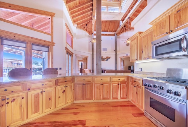 kitchen featuring light hardwood / wood-style flooring, beamed ceiling, appliances with stainless steel finishes, and wooden ceiling