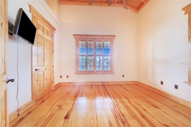 unfurnished bedroom featuring light hardwood / wood-style flooring and lofted ceiling with beams