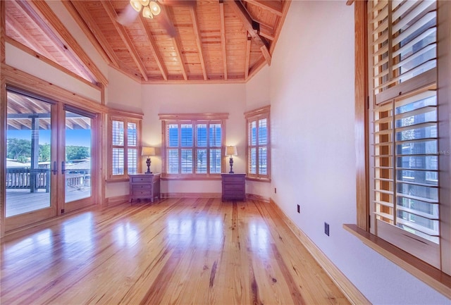 unfurnished room with beam ceiling, light hardwood / wood-style floors, wooden ceiling, and ceiling fan