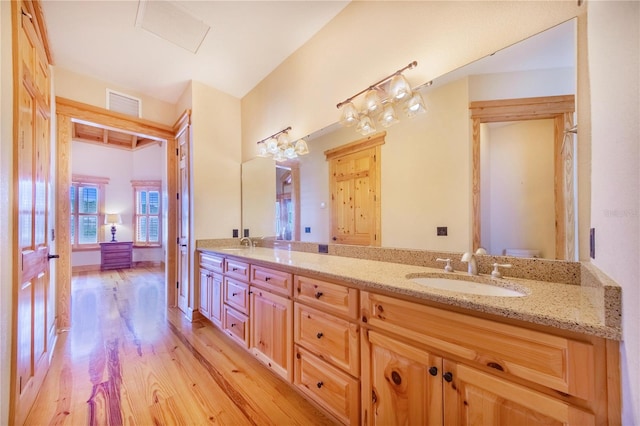 bathroom with vanity, hardwood / wood-style floors, and toilet