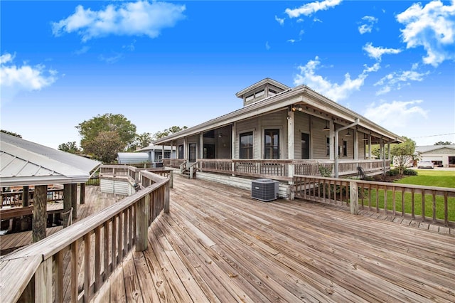 wooden terrace featuring central AC and a yard