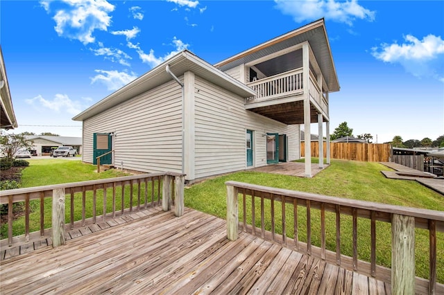 wooden deck featuring a yard and a patio