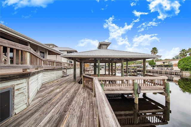 view of dock featuring a gazebo and a water view