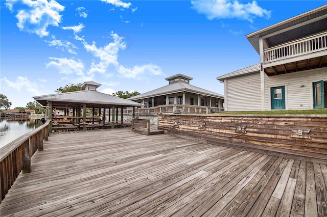 wooden terrace with a gazebo and a water view