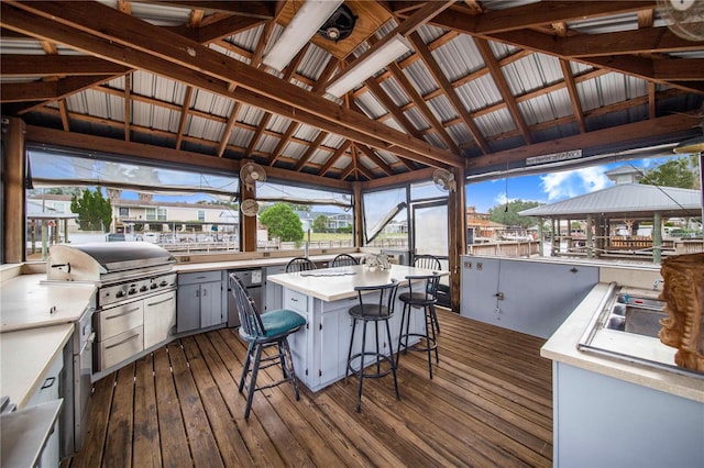 wooden terrace featuring exterior bar and a gazebo