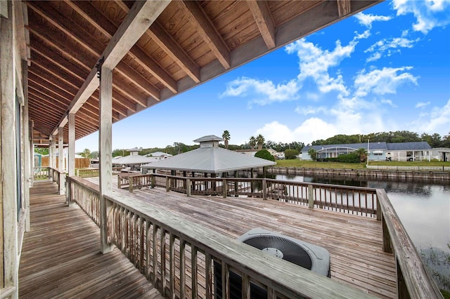 view of dock with a gazebo and a water view