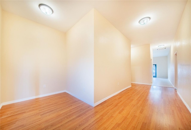 hallway with light hardwood / wood-style floors