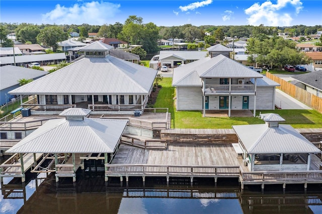 view of dock with a lawn and a deck with water view