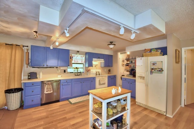 kitchen with white appliances, blue cabinetry, sink, and a textured ceiling