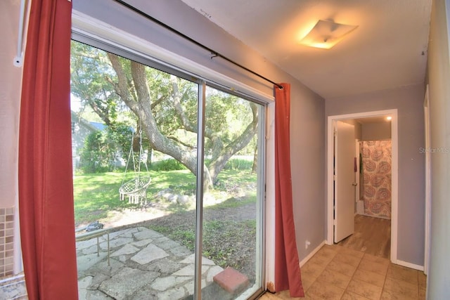 doorway with light tile patterned floors