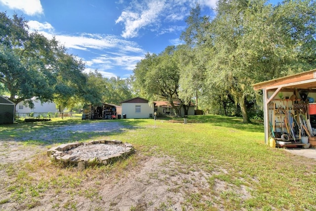 view of yard with a fire pit