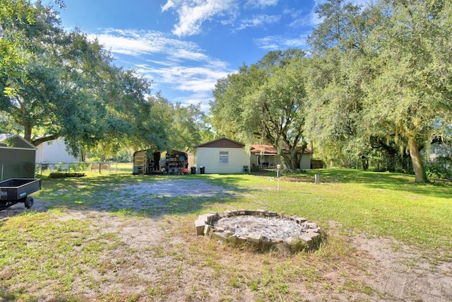 view of yard with a fire pit